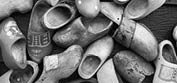 Europe, Netherlands, Zaanse Schans. Black and white image of assorted wooden shoes.